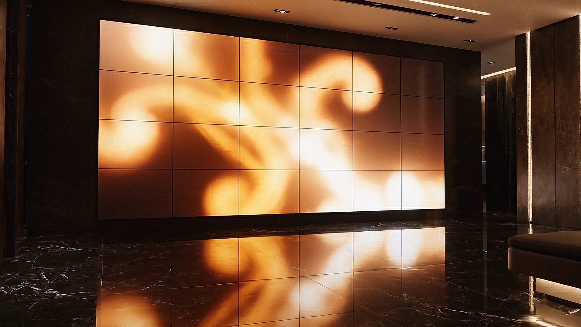 A large video wall glowing in a dark stone lobby.